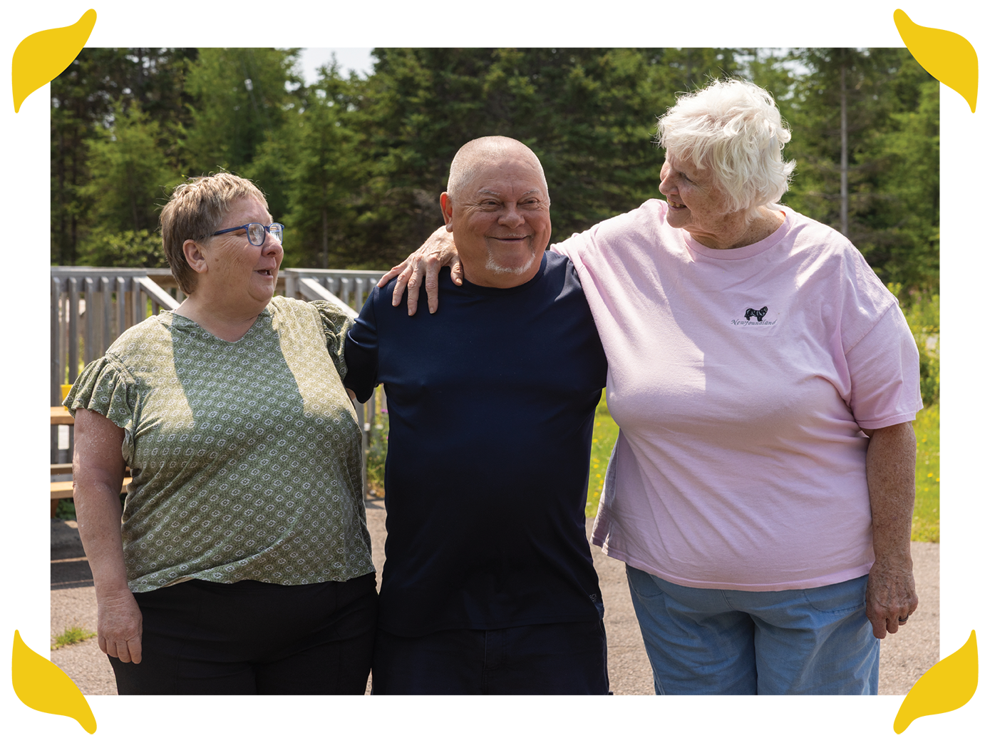 A man and two woman standing together outside
