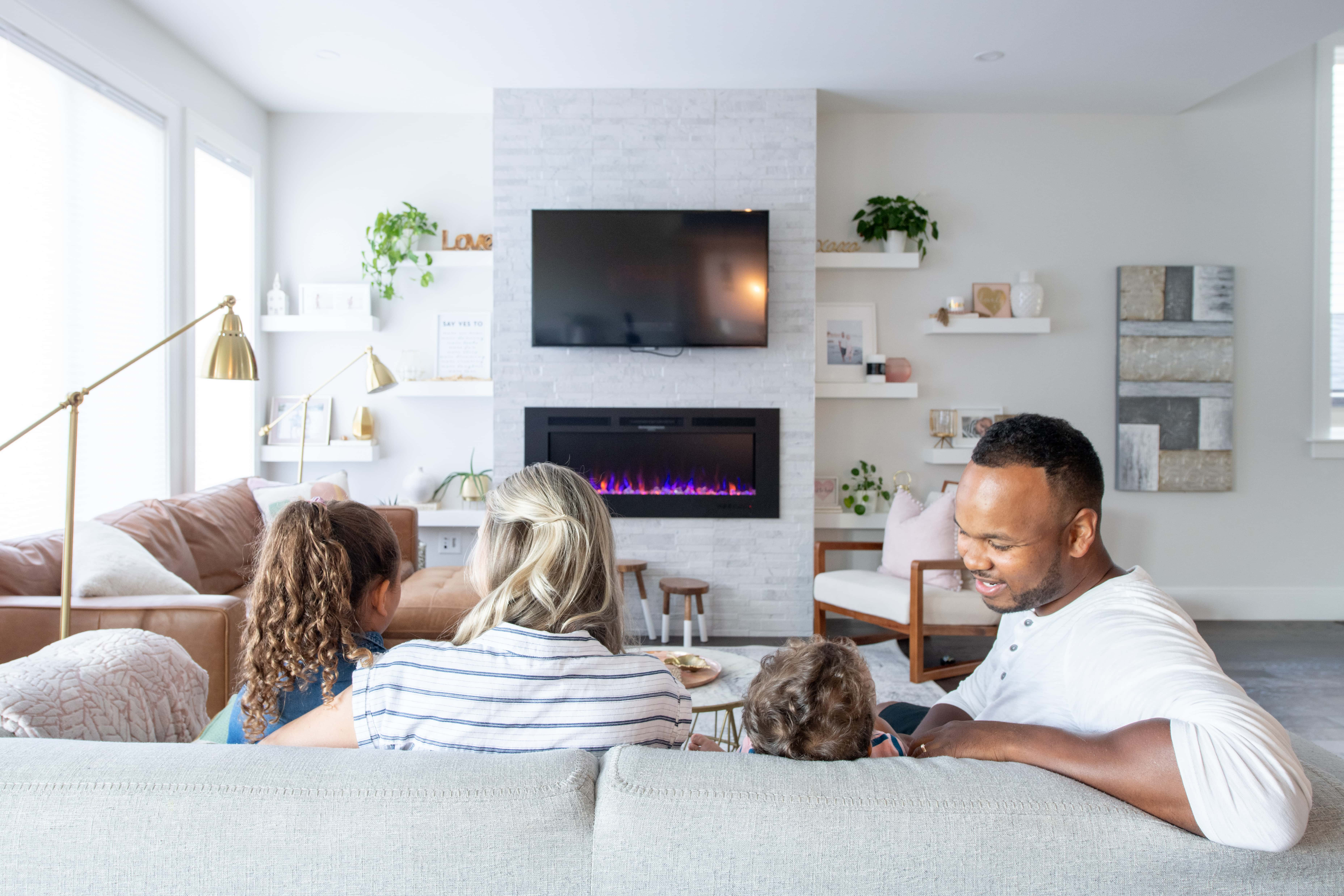 A family of four sitting on a couch